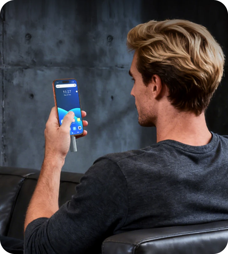 Man relaxing on couch with smartphone